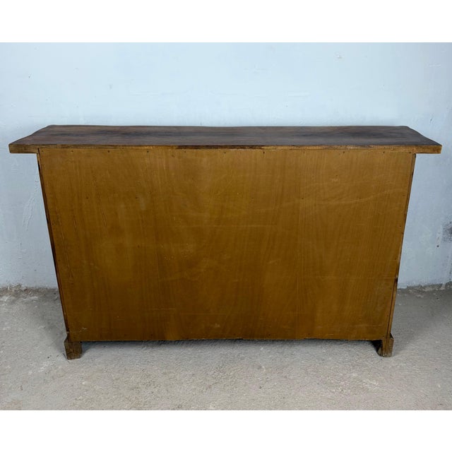 Beautiful Spanish sideboard crafted in solid walnut, featuring three upper drawers above three paneled cabinet doors with...