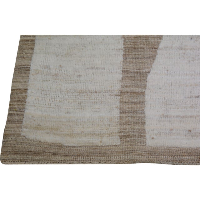 Hand-knotted with care using traditional rug making techniques, this wool rug blends timeless craftsmanship with a modern...