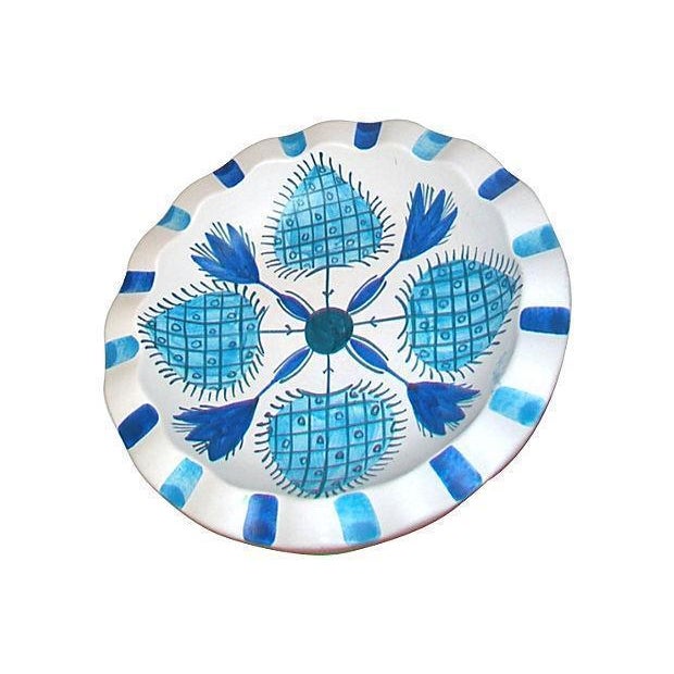 Mid-Century Modern blue and white art pottery dish with a hand painted design. This Mid-Century round ceramic dish has a...