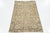 This vintage hand-knotted Persian rug has a beige field with accents in blue and brown throughout the design. This rug...