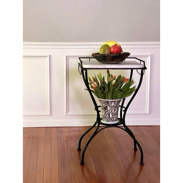 Art Deco period black iron table, display stand with a white marble top and towel bars, circa 1930s. A versatile,...