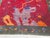 Vintage Chinese Art Deco rug featuring a richly saturated crimson field framed by an olive green border adorned with...