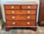 A 19th century English chest in warm mahogany, fitted with two short drawers over three long, each front outlined in fine...