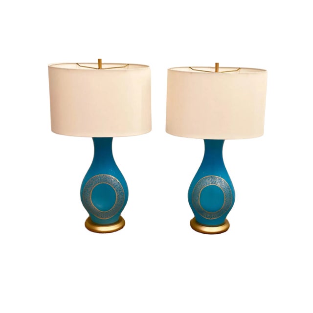 This is a really awesome pair of vintage Murano glass lamps. The lamp vessel is made in a striking bright aqua blue color...