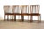 A set of four mid century modern mahogany frame dining chairs with black vinyl seats. Maker unknown. Extremely well made....