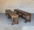 An unusual pair of large benches made of solid teak wood that feature stretchers supported by a central set of legs. The...
