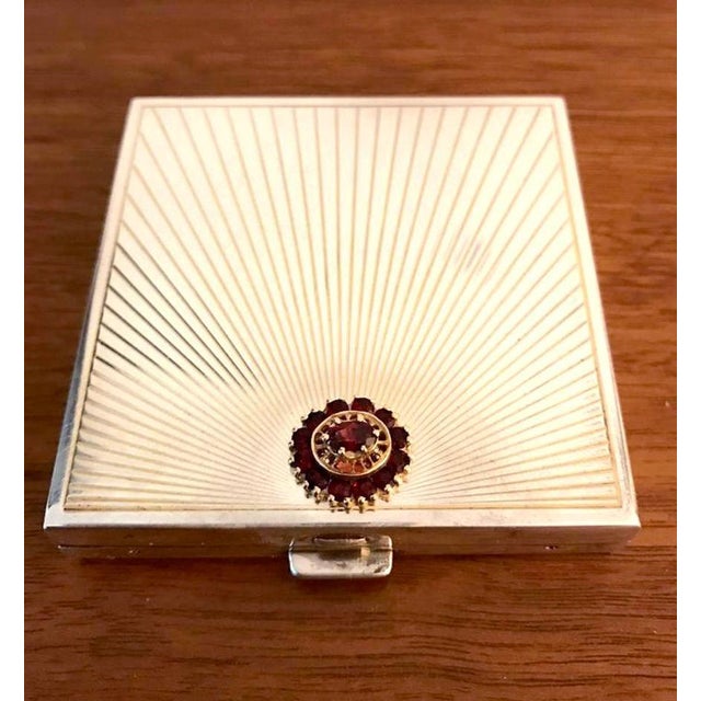 A fine Cartier compact case in the iconic Art Deco style, circa 1930s. Sterling silver with gold gilt interior that...