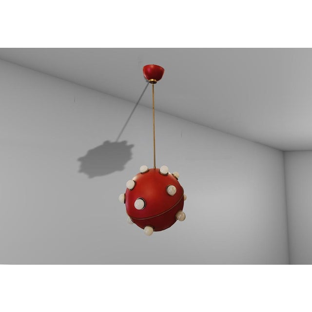 Very rare Chandelier Model 553 by Oscar Torlasco for Lumi circa 1960s. Large red enameled metal sphere with brass diagonal...