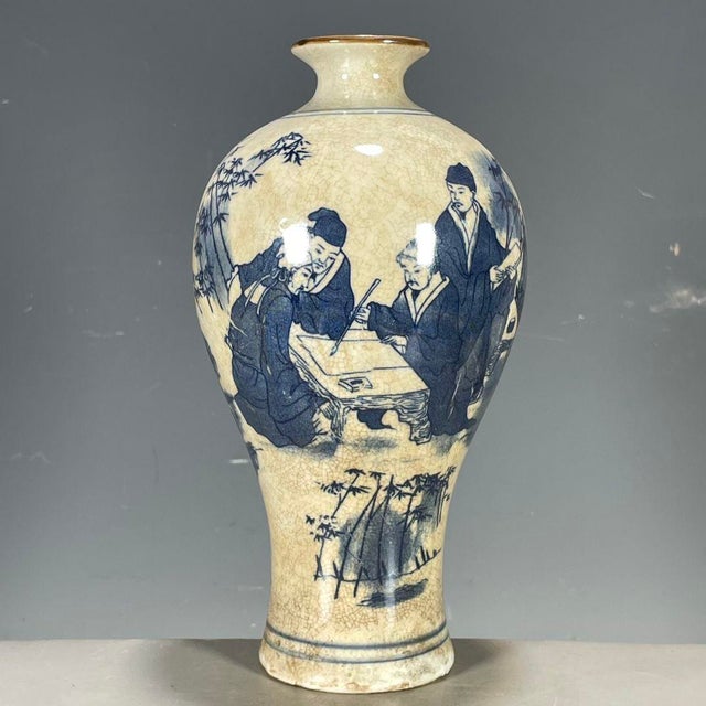 A charming Chinese blue and white porcelain vase featuring a distinctive all-over crackle (Ge-type) glaze. The vase has a...