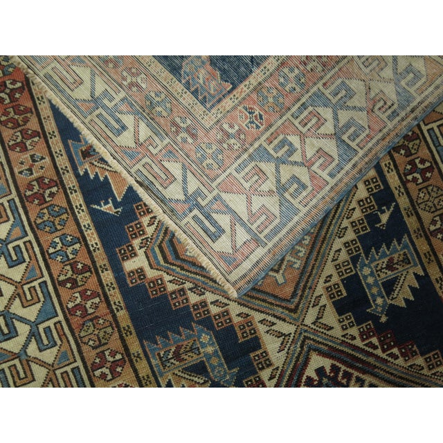 Early 20th century tribal inspired antique Caucasian Kazak rug, predominantly blues and cream The Caucasian nomad wove...