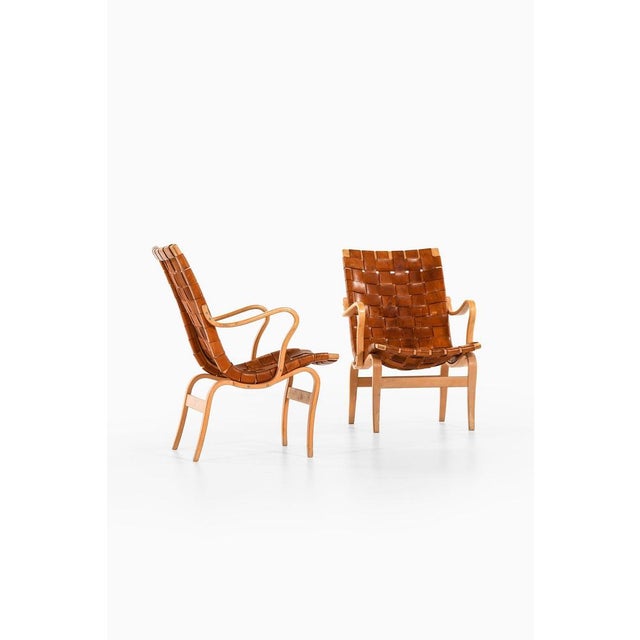 Pair of easy chairs in laminated birch and original leather webbing by bruno mathsson, 1968 additional information:...