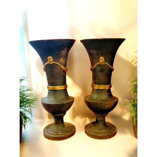 Pair of neoclassical Tuscan vases from the early 1800s, in terracotta with a beautiful dark patina and gold in the...