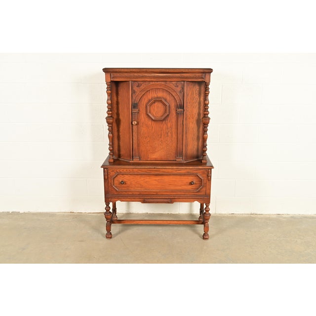 An exceptional antique English Jacobean, Tudor, Victorian, or Renaissance Revival style bar cabinet or dining cabinet In...