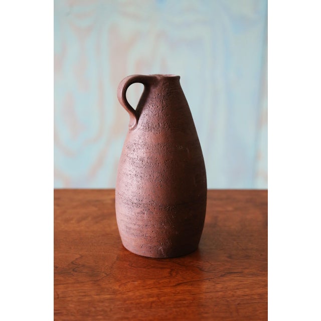 A vintage earthenware jug vase with handle. Signed illegibly. Great browns and textures. c. 1970. Dimensions: 8.25” High...