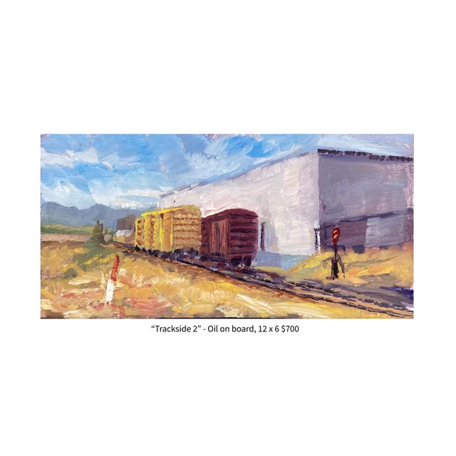 Trackside 2 captures a serene moment at a railway yard, where weathered freight cars stand against a backdrop of soft blue...