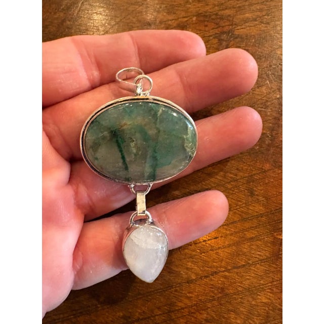 Beautiful vintage sterling silver pendant featuring an emerald in matrix stone and a moonstone.