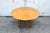 Table with a solid worked brass structure and a round wooden top. Italian production 1970s