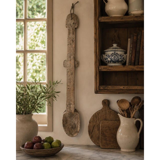 A beautifully worn 19th century French country wooden spoon, hand-carved from a single piece of wood with a long, elegant...