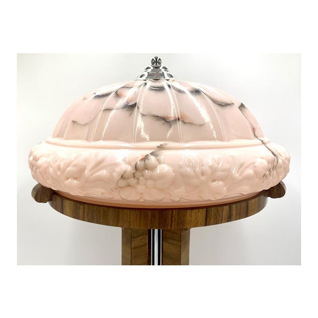 Art Deco table lamp with a large decorative pink shade. Made in Poland in the 1950s. The posture will be made of walnut...