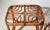 Pair of vintage rattan side tables featuring an intricate looped fretwork top design, hand bent and woven in a continuous...