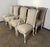 This elegant set of eight French dining chairs features classic Louis XV styling with gently curving cabriole legs, carved...