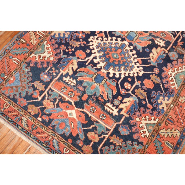 An early 20th century traditional navy blue field Persian Heriz carpet with a geometric all over design. Measures: 5'x...
