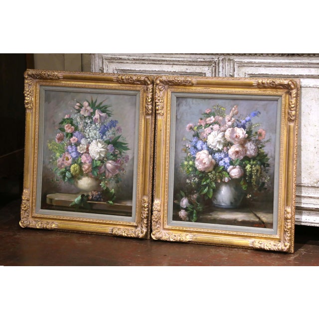 Painted in America circa 1950, this elegant pair of vintage floral still life paintings is the work of artist John W. Orth...