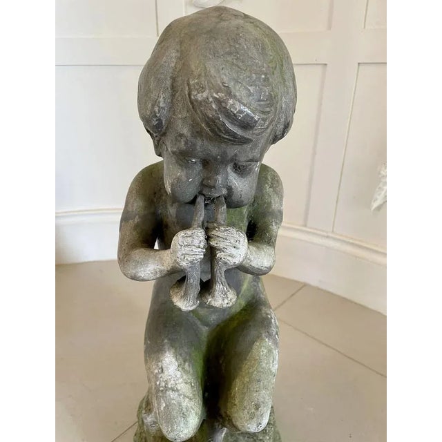 Unusual antique Victorian quality lead figure of a satyr musician sat upon a rock playing a flute type instrument. In...
