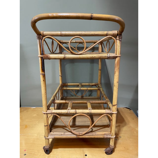 Fabulous mid century bar cart Made of bamboo and glass What a stylish piece that is also functional!