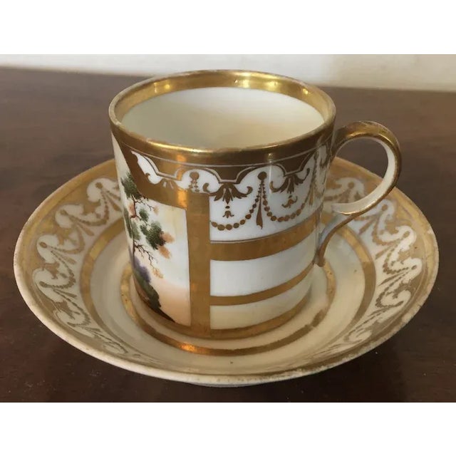 Antique early 19th c. French Empire Paris porcelain coffee can and saucer by Marc Schoelcher circa 1810. The cup hand...
