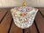 This item is a vintage porcelain lidded hexagon dish in a floral and gold pattern, which could be a sugar bowl or a...
