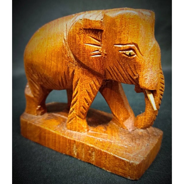 Add a touch of rustic charm to your home decor with this petite hand-carved wooden elephant figurine. Perfect for...