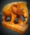 Add a touch of rustic charm to your home decor with this petite hand-carved wooden elephant figurine. Perfect for...
