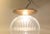 Large pendant light composed of cast fluted glass and a top diffuser/distributor in brass. Anonymously made in Scandinavia...