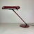 Orientable and dimmable desk or table lamp named ring a 400 and made in red scarlet enameled metal, designed by bruno...