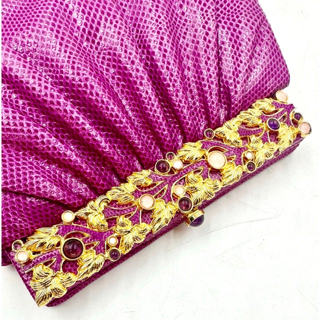 This stylish KARUNG skin bag in bright jewel tone pink/fuschia navy features a semi-precious gem studded top frame in a...