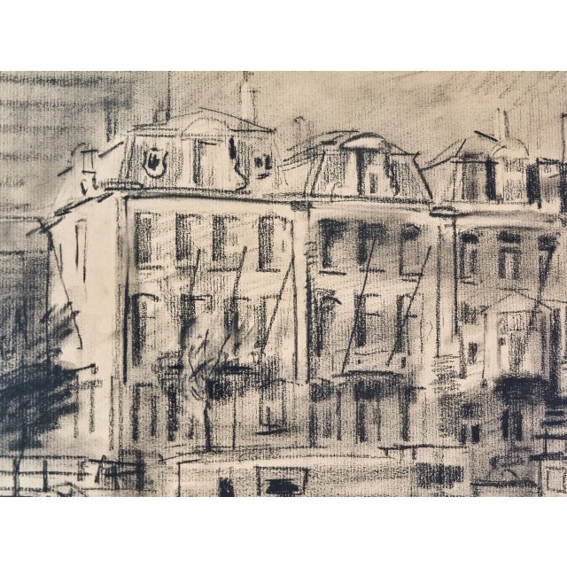 Charcoal drawing depicting a city waterfront with historic houses and moored ships, signed Engelman 1980. The work is made...