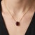 Elevate your jewelry collection with this elegant Garnet Solitaire Necklace, featuring a richly colored oval-cut garnet...