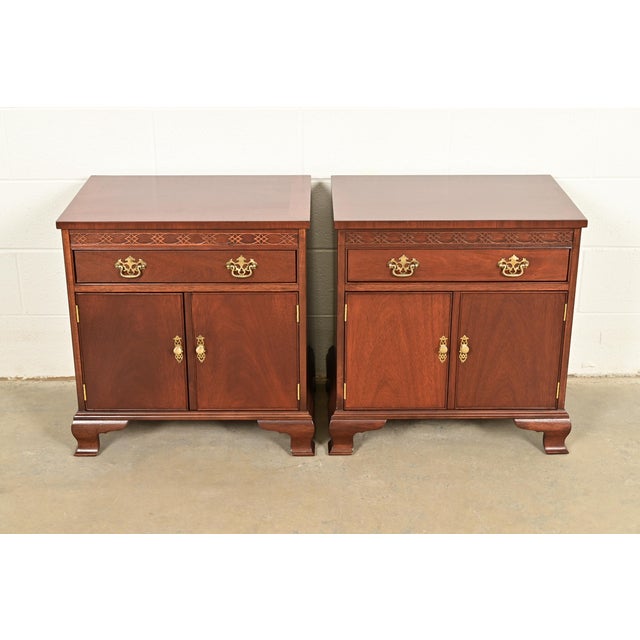 A beautiful pair of Georgian or Chippendale style nightstands or end tables By Baker Furniture USA, Circa 1980s Carved...