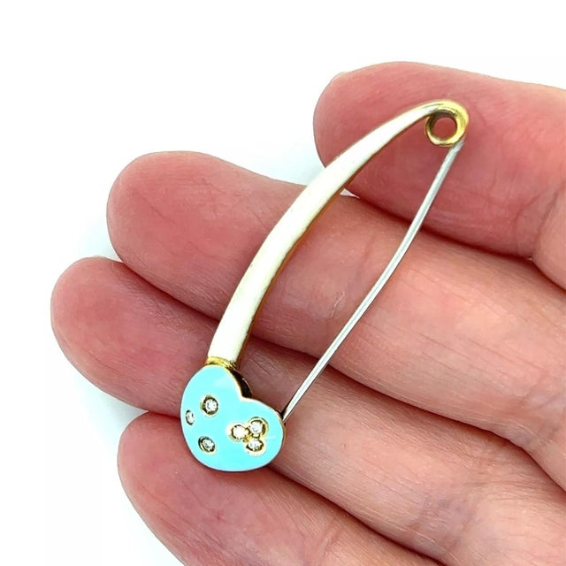 This an an authentic safety pin brooch from Aaron Basha, it is crafted from 18k yellow gold with a silver metal pin. The...