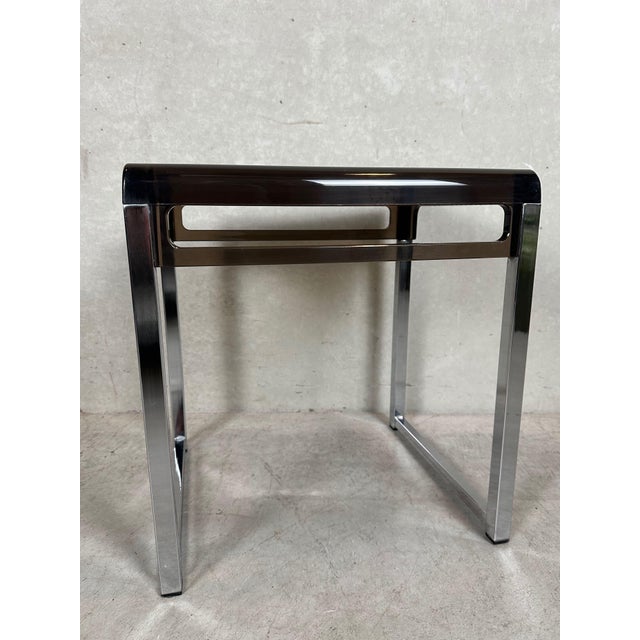 Vintage side table in chrome and smoked acrylic glass. Designed by Marc Berthier. Height: 41 cm. Width: 38 cm. Depth: 32...
