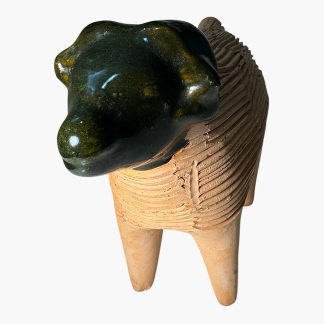 Charming handmade-style ceramic sheep (or ram) figurine featuring a textured terracotta body and a contrasting glossy dark...