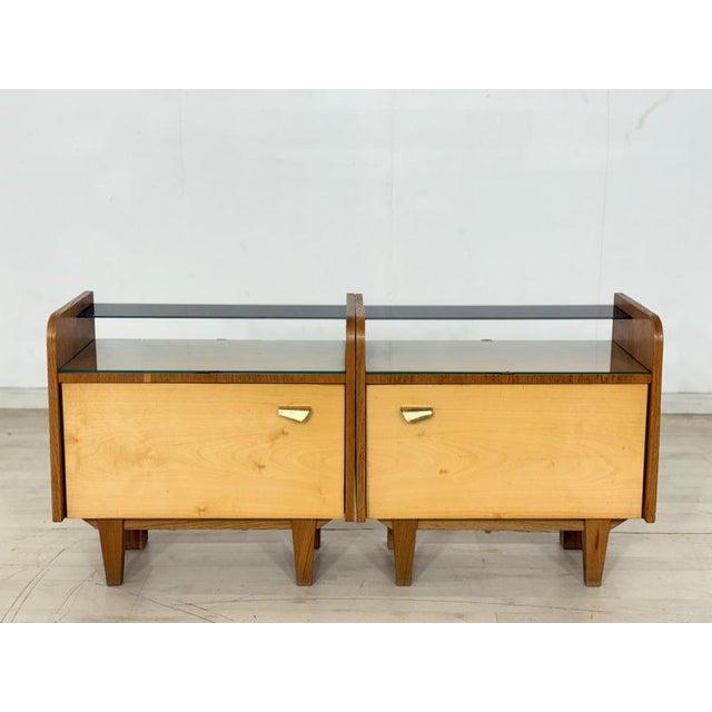 A beautiful set of two vintage bedside tables from the 1960s. These pieces of furniture impress with their simple,...