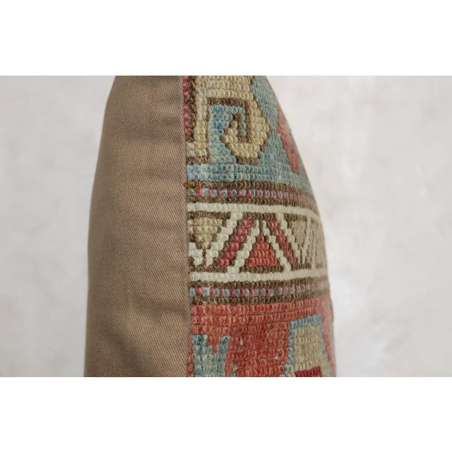 Pillow made from an early 20th century caucasian rug with cotton backing. Zipper closure and foam insert provided. 16'' x...