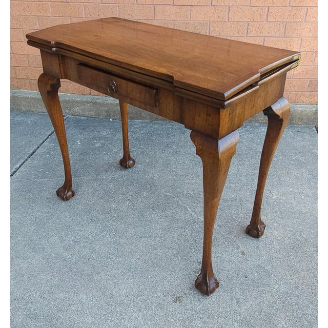 An 18th Century Chippendale Mahogany and Tooled Leather Fold Top Games Table / console table with satinwood inlay,...