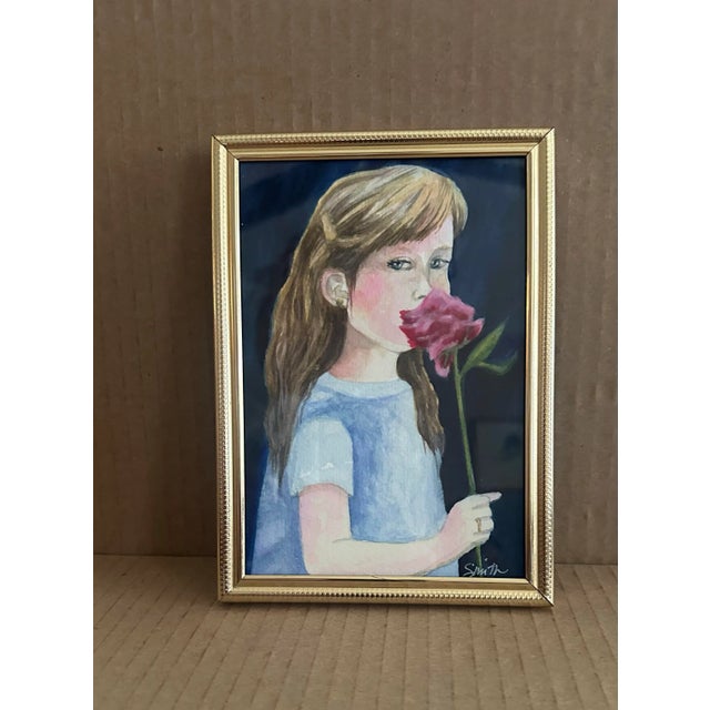 This expressive watercolor portrait of a young girl holding a pink carnation conveys innocence and introspection. Framed...