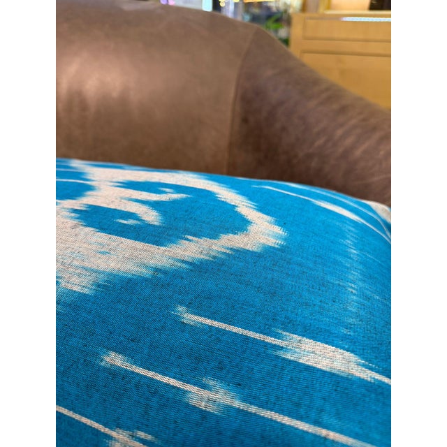 Large, open oval forms drift across a sky blue silk ground, each shape dissolving at its edges into the characteristic...
