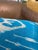 Large, open oval forms drift across a sky blue silk ground, each shape dissolving at its edges into the characteristic...