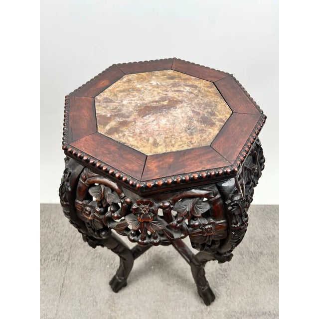 Elegant antique Oriental Chinese rosewood fern stand, showcasing exceptional hand carved craftsmanship. The octagonal top...
