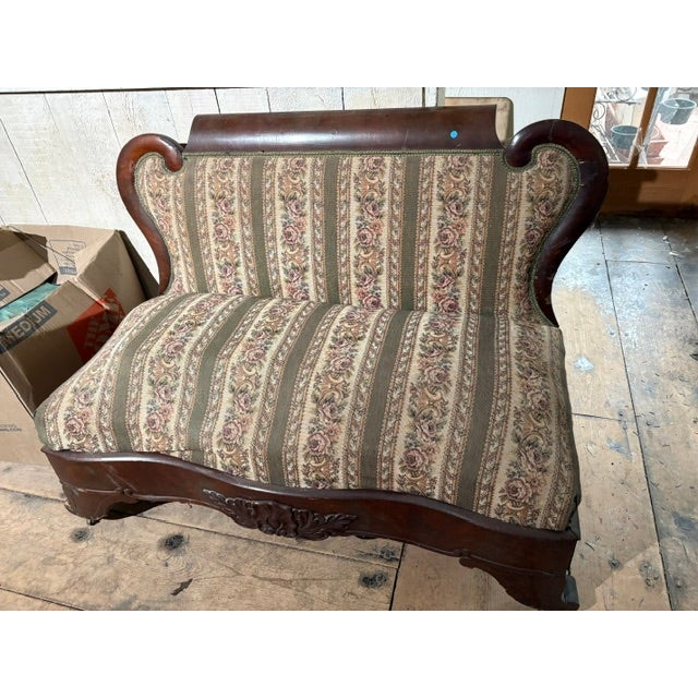 Elegant rare antique arm less Empire/Victorian parlor settee. Vintage floral and spring type upholstery with carved Walnut...